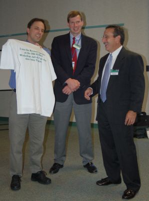 Dr. Camarda receives a t-shirt from Jeff Bolognese and Jim Loughlin